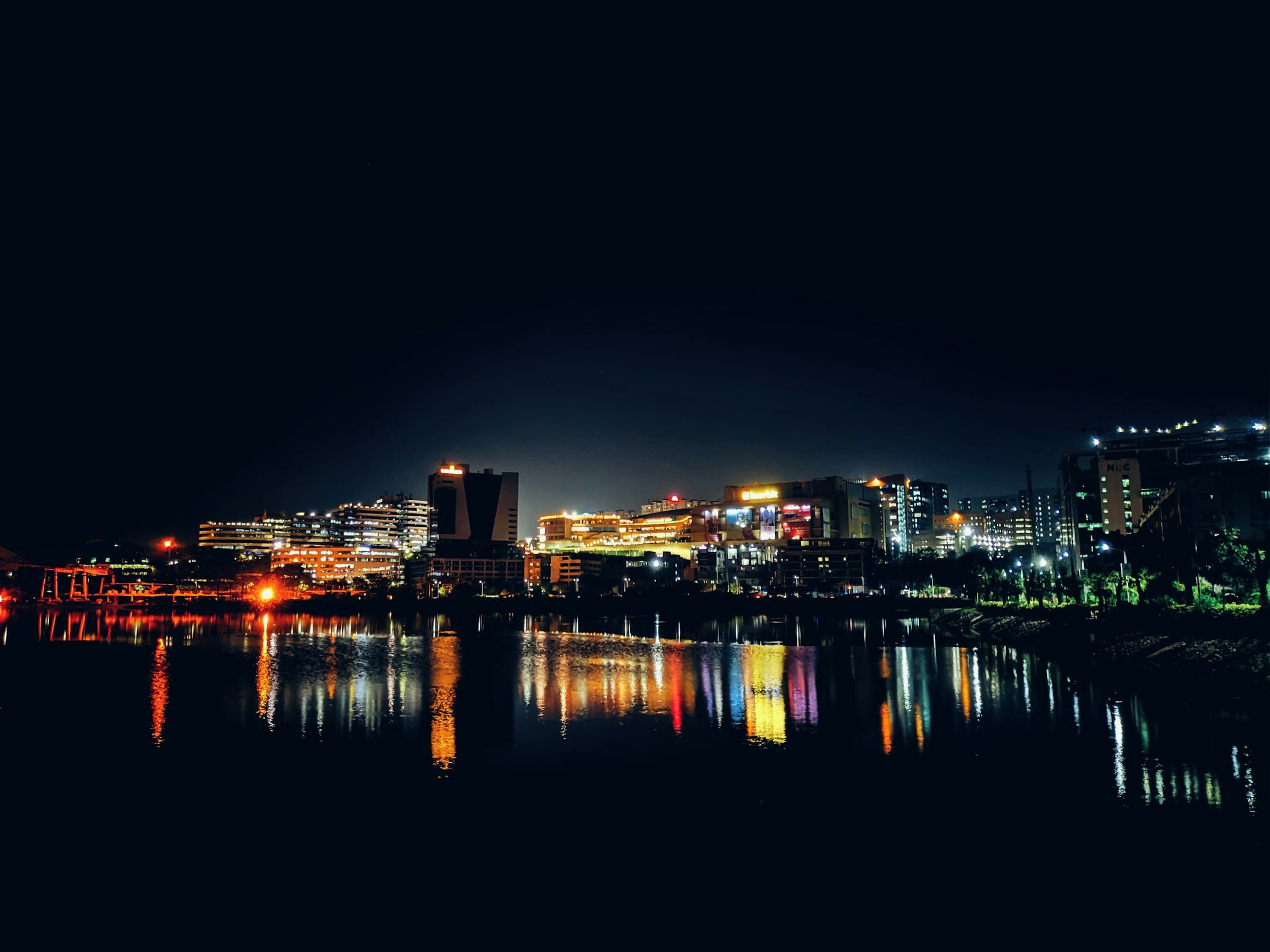 Hyderabad's western corridor skyline at night reflected in Durgam Cheruvu lake
