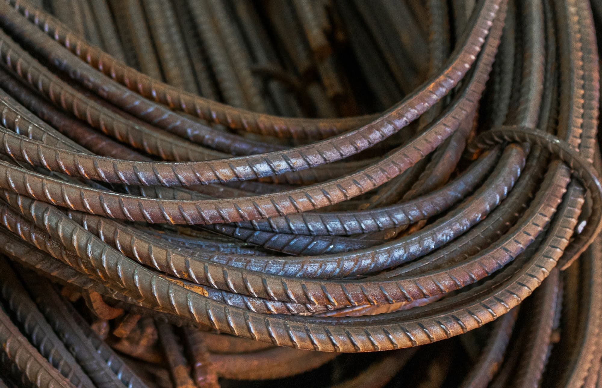 Coiled reinforcement steel stacked on a construction site